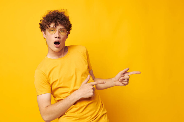 cute red-haired guy wearing stylish glasses yellow t-shirt posing Lifestyle unaltered - Foto, Imagem