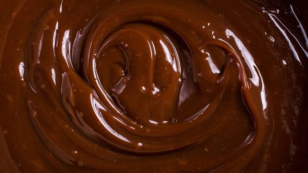 Delicious chocolate cream or brown caramel sauce as ingredient for tasty homemade dessert - 写真・画像
