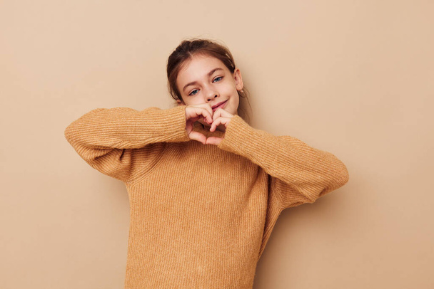 pretty young girl in sweater posing hand gestures isolated background - Foto, imagen