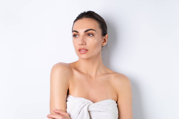 Sluiten beauty portret van een topless vrouw met perfecte huid en natuurlijke make-up, mollige naakte lippen, op een witte achtergrond - Foto, afbeelding