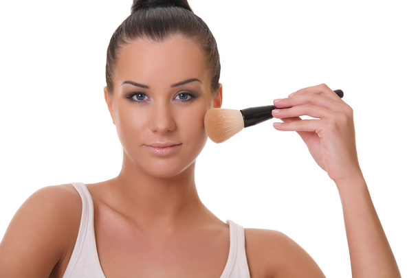Beautiful young woman holds the make-up brushes - Photo, image
