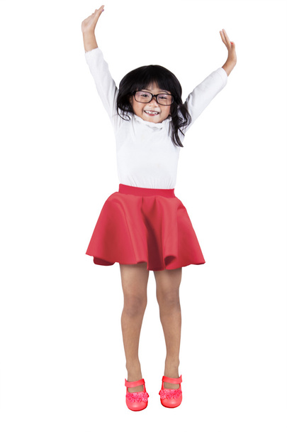 Little girl jump in studio - Фото, изображение