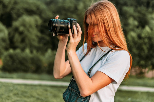 Ginger teen, girl taking photos with camera - Fotografie, Obrázek