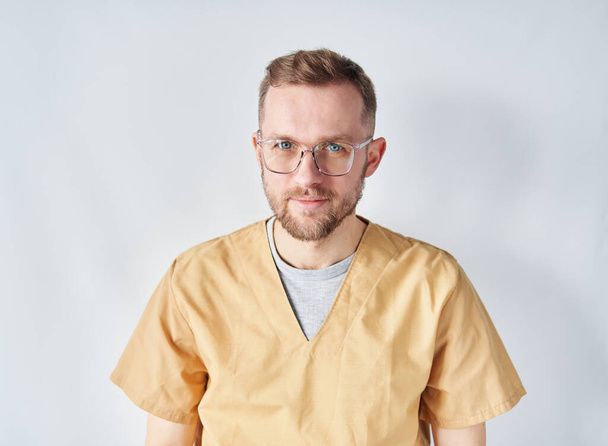 Χαρούμενος καυκάσιος άνδρας γιατρός ή νοσοκόμος με γυαλιά - Φωτογραφία, εικόνα