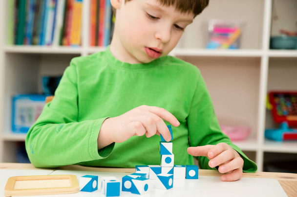 cubes for logical tasks. A tool for the child's perception, concentration, logical and analytical thinking. Implement for measuring a child's intelligence, training patience, maintenance of attention - Фото, зображення