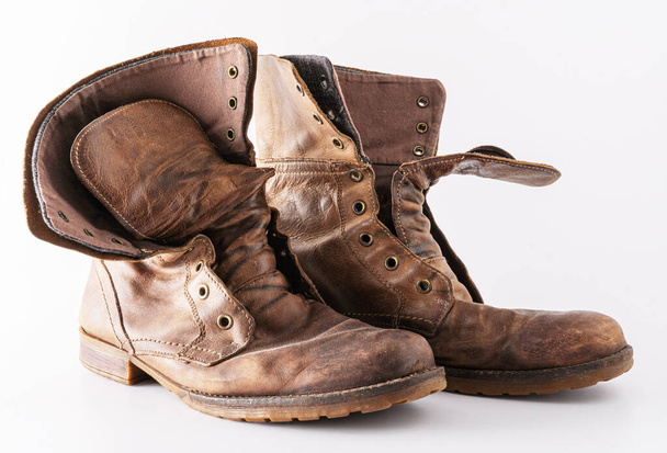 Old shoes on a white background. Leather brown shoe. Worn shoes. - 写真・画像