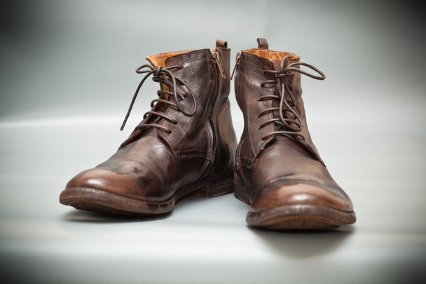 Розкішне шкіряне чоловічого взуття. Високі осінні та весняні туфлі коричневого кольору на сірому фоні
 - Фото, зображення