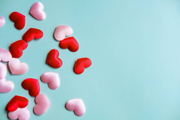 Valentine's Day background. White and red hearts on pastel blue background, top view, copy space. Valentines day concept. - Фото, изображение