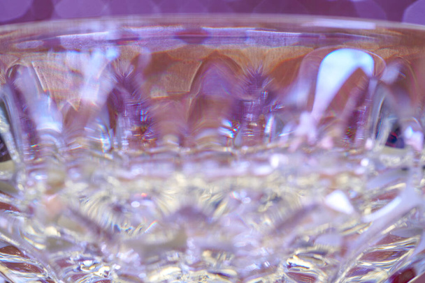 Glass made of crystal-like materials photographed in the studio with colorful background - Φωτογραφία, εικόνα
