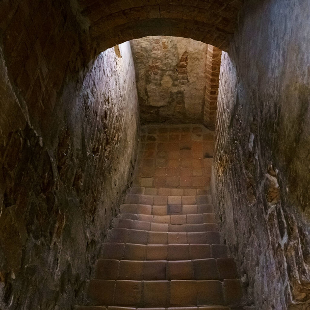 Staircase in an old castle going to the dungeon. Medieval and gothic concept. Background for text. - Zdjęcie, obraz