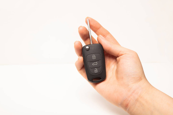 Car key in hand isolated on white background - Valokuva, kuva