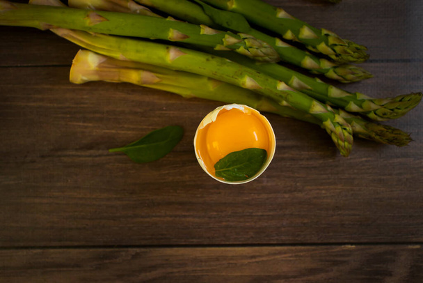 asparagus, raw egg on wooden background - Photo, Image
