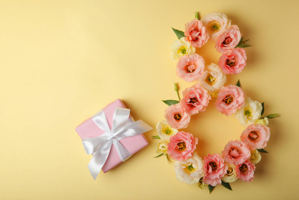 Flowers in the shape of number 8 on a colored background with place for text - Photo, Image