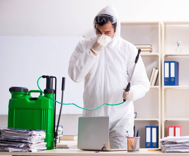 The professional contractor doing pest control at office - 写真・画像