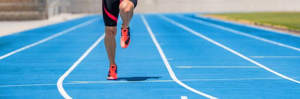 Athlete sprinter runner training sprinting dynamic run on running tracks at stadium. Panoramic banner of man legs and running shoes - Photo, Image