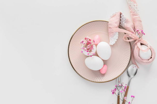 Beautiful Easter table setting with gypsophila flowers on white background - 写真・画像