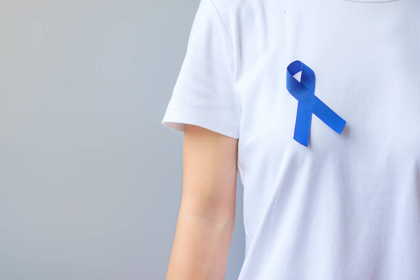 March Colorectal Cancer Awareness month,  dark Blue Ribbon for supporting people living and illness. Healthcare, hope and World cancer day concept - Foto, Imagem