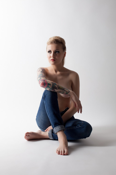 Tattooed model posing topless in jeans - Fotó, kép