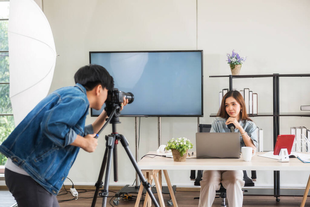 Behind the scene concept. Videographer prepare to record footage before streaming live online of young Asian woman blogger with studio lighting. broadcasting vlogger, internet influencer. - Photo, Image