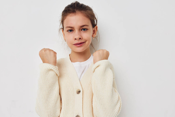 little girl posing in a white sweater childhood unaltered - Foto, Imagem
