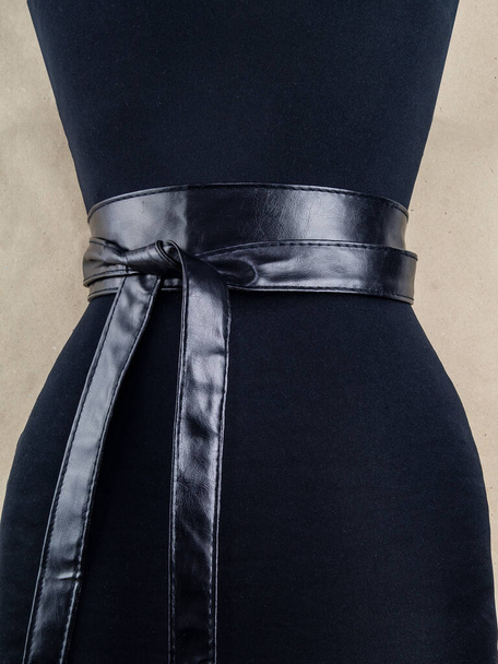 Belt on the woman's waist. The image and the option of tying. Image on a light background - Fotografie, Obrázek