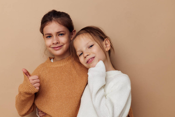 two funny little girls in sweaters posing childhood - Zdjęcie, obraz