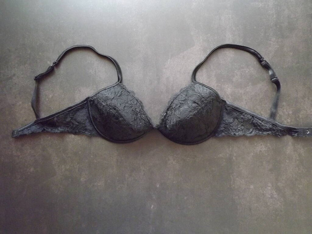 Black guipure bra on a black background, layout - Photo, Image