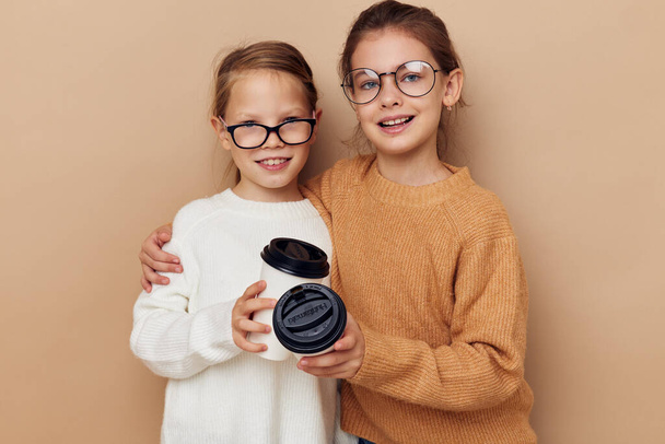 little girls hugging together glass with drink - Valokuva, kuva