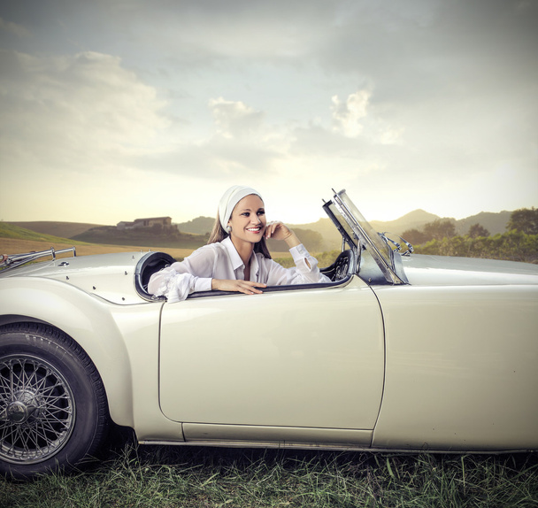 Smiling girl in a vintage car - Photo, Image