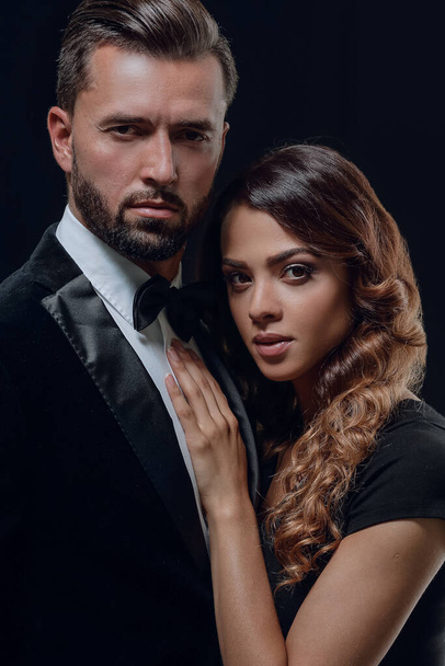portrait of fashion couple on black background - Foto, imagen