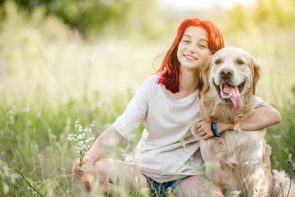 Teen girl with golden retriever dog - Fotó, kép