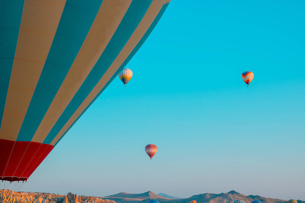 Hot air ballooning. Cappadocia activities background photo. hot air balloons on the sky in the morning. selective focus. noise included. - Photo, image
