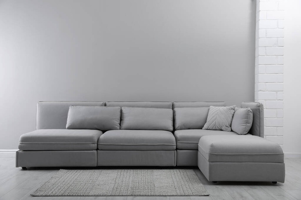 Large grey sofa in living room. Interior design - Foto, afbeelding