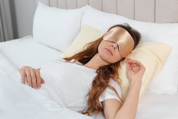 Woman with sleep mask in bed at home - Φωτογραφία, εικόνα
