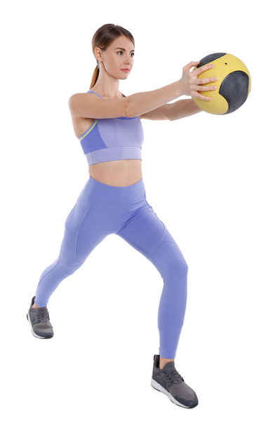 Athletic woman doing exercise with medicine ball isolated on white - Foto, afbeelding