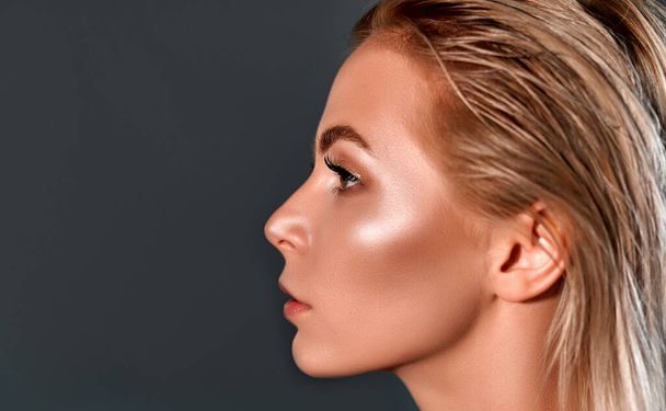 Beautiful Young Woman in profile with Clean Fresh Skin .Girl beauty face care. Cosmetology , beauty and spa . - Photo, Image
