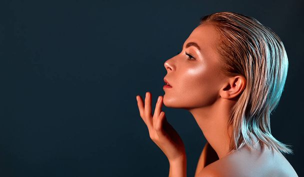 A beautiful woman in profile with perfect skin and bare shoulders against a gray background. Girl beauty face care. Cosmetology , beauty and spa . - Fotoğraf, Görsel