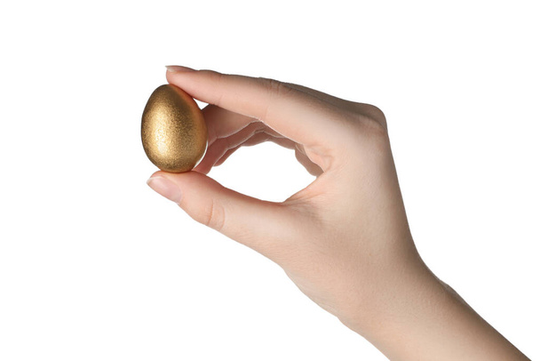 Woman holding golden quail egg on white background, closeup - Foto, Bild