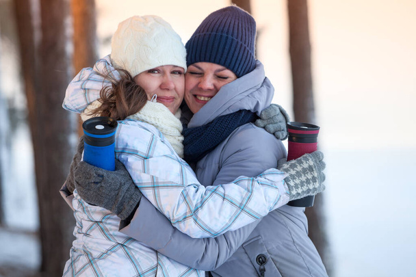 Two women hugging together, outdoor - Fotografie, Obrázek