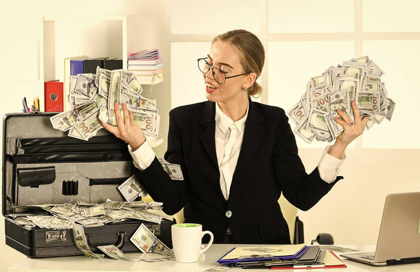 widescale earnings. corporate leather bag. sexy woman with case at workstation. happiness and success. Businesswoman holding briefcase. suitcase with money. good deal. modern life and business - 写真・画像