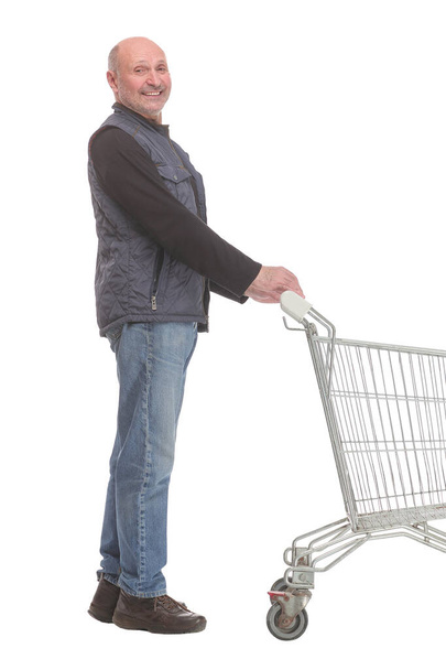 Smiling mature man holding shopping bags walking forward - Фото, зображення