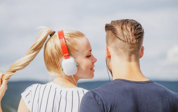 Lovely couple listening music. Relaxing outdoors together. Relationships concept. - Foto, Imagem