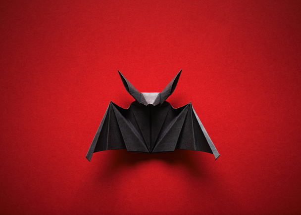 Origami bat on a red background - Foto, Bild