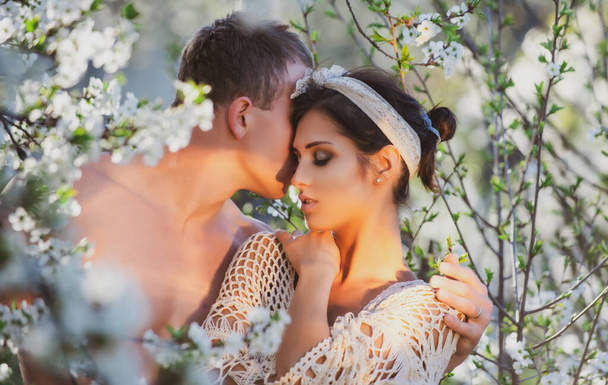 Springtime Nature. Spring love story. Sensual couple. Honeymoon. Cherry blossom tree. - Фото, изображение