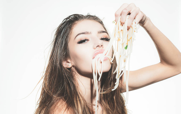 Beautiful girl with spaghetti on mouth. Spaghetti pasta in mouth. Eating pasta. - Foto, Imagem