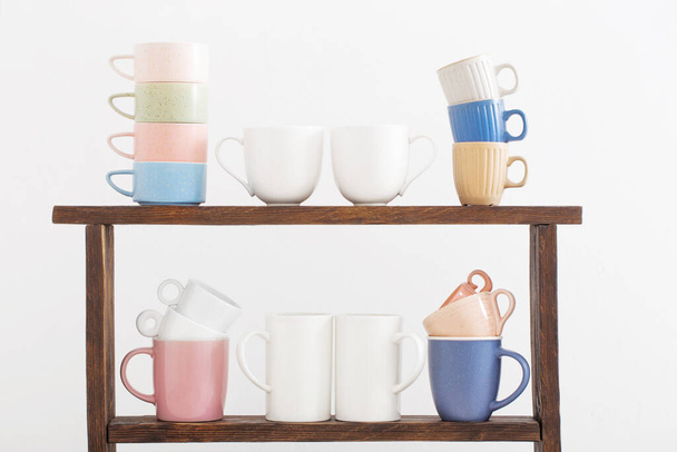 colorful cups on  wooden shelf on  white background - Photo, Image