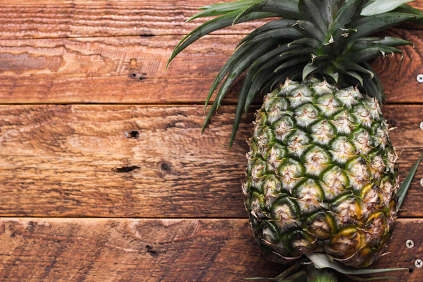 Pineapples on a brown wooden table in Thailand. - Photo, Image
