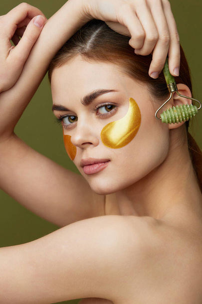 pretty woman skin care face patches bare shoulders hygiene green background - Foto, Imagen