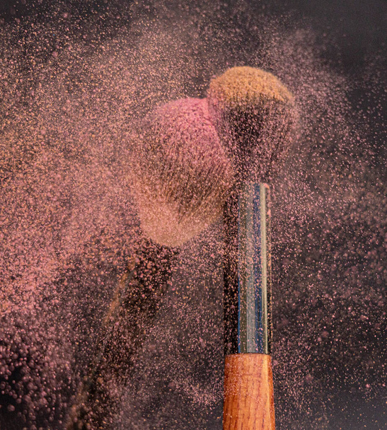 Batumi, Georgia - February 10, 2022: Two brushes with blush and powder hitting each other - Foto, afbeelding