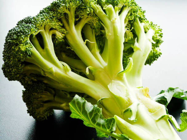 Broccoli cabbage on the black background. Shallow dof. Top view. - Foto, Imagen